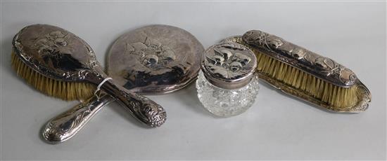 A matched silver five piece dressing table set, decorated with Reynolds Angels.